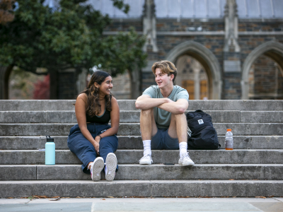 students sitting on stairs on west campus