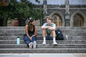 students sitting on stairs on west campus